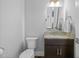 Powder room featuring single sink vanity, dark wood cabinet, and granite countertop at 76 Gentry Dr, Pittsboro, NC 27312