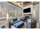 Cozy screened porch with a fireplace, TV, and comfortable seating at 76 Gentry Dr, Pittsboro, NC 27312