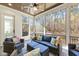 Relaxing screened porch featuring comfortable seating, ceiling fan, and views of the woods at 76 Gentry Dr, Pittsboro, NC 27312