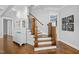 Elegant staircase with wooden railings and a white cabinet on a hardwood floor at 76 Gentry Dr, Pittsboro, NC 27312