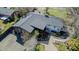 An aerial view of a home with a dark roof, beautiful yard with patio, and surrounding greenery at 761 S Eighth St, Mebane, NC 27302