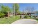 A backyard with mature trees, a hammock, a water feature, and a small building at 761 S Eighth St, Mebane, NC 27302