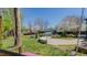 A backyard with grass, a swing, mature trees, a small guest house, and landscaping at 761 S Eighth St, Mebane, NC 27302