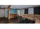 Finished basement with a kitchenette bar, dark laminate flooring, and a leather couch at 761 S Eighth St, Mebane, NC 27302