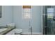 Tranquil bathroom features a toilet, stone sink, bamboo blind, and glass shower at 761 S Eighth St, Mebane, NC 27302
