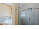 Bathroom features a soaking tub, glass shower, and beige walls with wood trim at 761 S Eighth St, Mebane, NC 27302