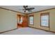 Carpeted bedroom featuring wood trim, natural light, and an attached sitting room at 761 S Eighth St, Mebane, NC 27302