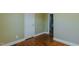 Empty bedroom with hardwood floors, green walls, white trim, and a white closet door at 761 S Eighth St, Mebane, NC 27302