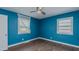 Bright blue empty bedroom featuring two windows, laminate flooring and ceiling fan at 761 S Eighth St, Mebane, NC 27302