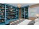 Bedroom with custom blue bookshelves, a decorative chandelier and a cozy bed at 761 S Eighth St, Mebane, NC 27302