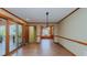 Open dining room featuring wood trim, hardwood floors, and sliding glass doors to the deck at 761 S Eighth St, Mebane, NC 27302