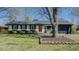 Charming single-story home with a well-maintained lawn, brick accents, and a bright red front door at 761 S Eighth St, Mebane, NC 27302