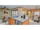 Open concept kitchen with stone countertops, stainless steel appliances, and an adjacent dining area at 761 S Eighth St, Mebane, NC 27302