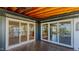 Covered wooden patio features a fan and sliding glass doors to the interior spaces at 761 S Eighth St, Mebane, NC 27302