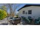 A backyard patio with seating, a white brick home, and a view of the landscaping at 761 S Eighth St, Mebane, NC 27302
