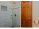 Glass enclosed shower features gray tiled walls, a shower head, and hardware at 761 S Eighth St, Mebane, NC 27302