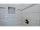 Shower features a recessed shelf and decorative accent tiles near bronze hardware at 761 S Eighth St, Mebane, NC 27302