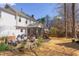Large backyard with pea gravel patio, string lights, mature trees, and well-maintained landscaping at 7816 Tylerton Dr, Raleigh, NC 27613