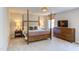 Spacious bedroom featuring a four-poster bed, neutral colors, and ample natural light at 7816 Tylerton Dr, Raleigh, NC 27613