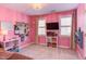 Fun bedroom with pink walls, modern furniture, and natural light through window at 7816 Tylerton Dr, Raleigh, NC 27613