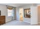Comfortable bedroom with large mirror showing the bed, an ensuite bathroom, and a bright window at 7816 Tylerton Dr, Raleigh, NC 27613