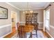 Traditional dining room with hardwood floors, chandelier, and classic china cabinet at 7816 Tylerton Dr, Raleigh, NC 27613