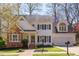 Charming two-story home with brick accents, black shutters, well-manicured lawn, and attached two-car garage at 7816 Tylerton Dr, Raleigh, NC 27613