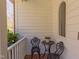 Welcoming front porch featuring brick flooring, cozy wrought-iron seating, and views of the manicured landscaping at 7816 Tylerton Dr, Raleigh, NC 27613