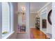 Open hallway featuring hardwood floors, and views into the adjacent office and living spaces at 7816 Tylerton Dr, Raleigh, NC 27613