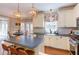Bright kitchen featuring an island, stainless steel appliances, custom cabinetry, and eat-in nook at 7816 Tylerton Dr, Raleigh, NC 27613