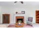 Charming living room with a brick fireplace, light-filled ambiance, and classic decor at 7816 Tylerton Dr, Raleigh, NC 27613