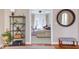 Stylish living room featuring hardwood floors, decorative shelving, and a view into another living space at 7816 Tylerton Dr, Raleigh, NC 27613