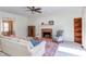 Inviting living room featuring a cozy fireplace, comfortable seating, and seamless flow to adjoining spaces at 7816 Tylerton Dr, Raleigh, NC 27613