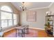 Bright and airy office space with hardwood floors, large arched window, and a modern chandelier at 7816 Tylerton Dr, Raleigh, NC 27613