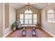 Sunlit office with hardwood floors, large windows, and ample workspace for productivity at 7816 Tylerton Dr, Raleigh, NC 27613