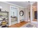 Home office with hardwood floors, a desk area, and a view into an adjacent living space at 7816 Tylerton Dr, Raleigh, NC 27613