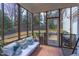 Comfortable screened porch with cozy seating, outdoor lighting and views of the backyard at 7816 Tylerton Dr, Raleigh, NC 27613