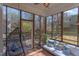 Relaxing screened porch with comfortable seating, hanging chair and views of the backyard at 7816 Tylerton Dr, Raleigh, NC 27613