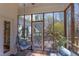 Relaxing screened porch with comfortable seating, hanging chair and views of the backyard at 7816 Tylerton Dr, Raleigh, NC 27613