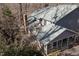 Aerial view of gray home featuring screened in porch, outdoor balcony, and wooded surroundings at 7917 Holly Springs Rd, Raleigh, NC 27606