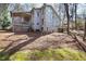 Backyard with large deck, wooded surroundings, and unique terraced stairs to a gazebo at 7917 Holly Springs Rd, Raleigh, NC 27606