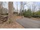 Backyard area with a basketball court, a playground, and a wooded surrounding at 7917 Holly Springs Rd, Raleigh, NC 27606