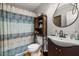 Bathroom with wood floors, a shower with a decorative curtain, and a dark-stained wood vanity with a sink at 7917 Holly Springs Rd, Raleigh, NC 27606