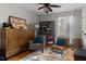 Comfortable bedroom featuring neutral walls, a stylish storage cabinet, seating, and natural light from a window at 7917 Holly Springs Rd, Raleigh, NC 27606