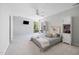 Bright bedroom with a ceiling fan, a large window, and built-in shelving for ample storage at 7917 Holly Springs Rd, Raleigh, NC 27606