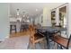 Bright breakfast nook with tile floors and a view into the adjacent kitchen with barstool seating at 7917 Holly Springs Rd, Raleigh, NC 27606