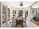 Sun-drenched breakfast nook featuring access to the backyard and a circular table with seating for four at 7917 Holly Springs Rd, Raleigh, NC 27606