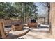 Back deck featuring an outdoor kitchen, a gazebo, a fire pit, and wooded surroundings at 7917 Holly Springs Rd, Raleigh, NC 27606