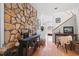 Entryway with stone accent wall, hardwood floors, staircase and desk with a chair and decorative items at 7917 Holly Springs Rd, Raleigh, NC 27606