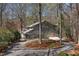 Exterior view of gray home with circle drive, mature trees, and attached two-car garage at 7917 Holly Springs Rd, Raleigh, NC 27606